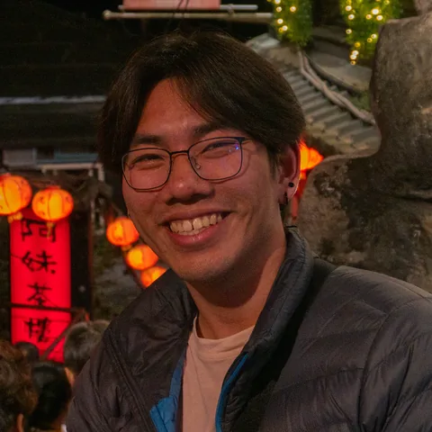 Gene smiling on a lantern-lit street at night